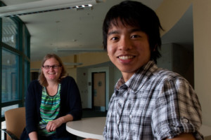 student and professor smiling academics