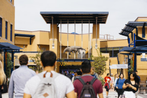 welcome students walk in front of UCI student center