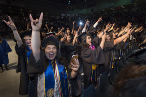 Students throw up the Zot hand sign