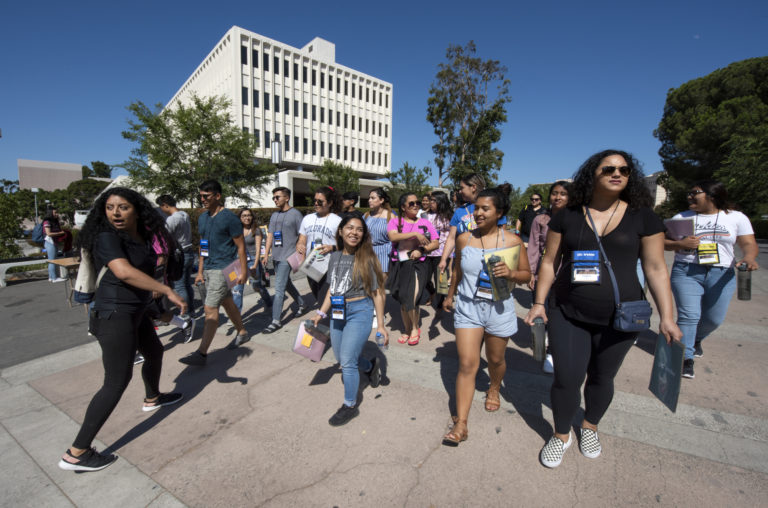 UCI students gives campus visitors a tour of the campus