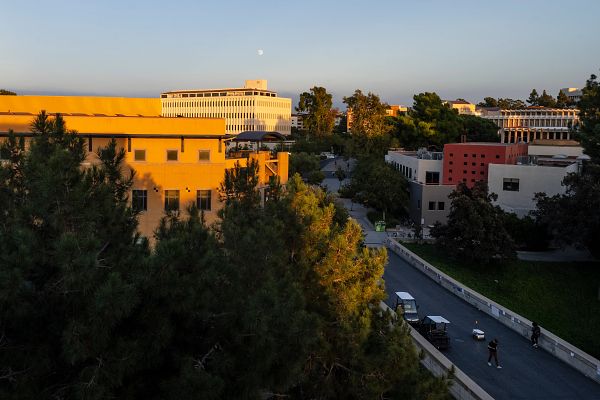 View of Aldrich Hall and the Student Center from Ring Road with the moon